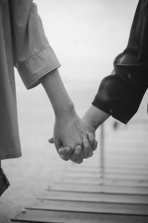 Free Grayscale Photography of Couple Holding Hands Stock Photo