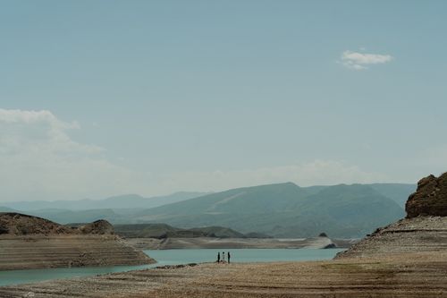 Free A scenic view of a vast mountainous landscape with a river, under a clear blue sky. Stock Photo
