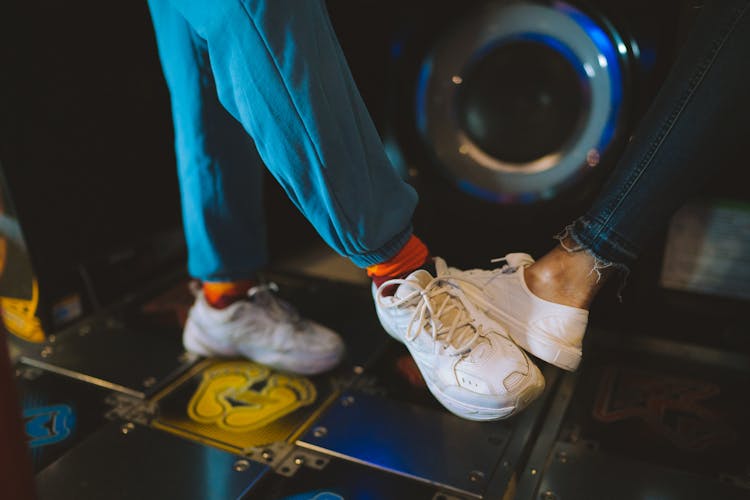 Close-up Of People Playing A Dance Game In An Arcade