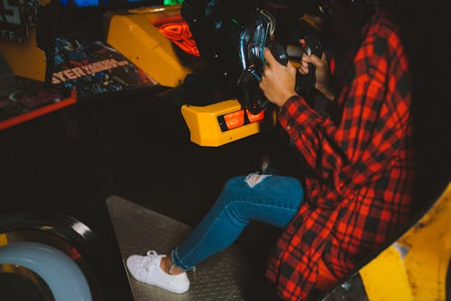 Woman Playing a Race in an Arcade