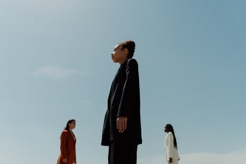 Low Angle Shot of Woman in Black Suit Standing Near Women 