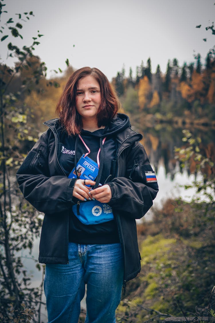 Portrait Of Russian Reporter Standing On Lake Shore