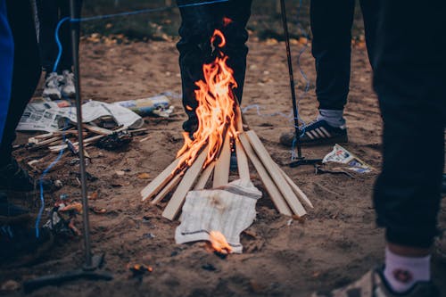 People Standing Around a Bonfire 