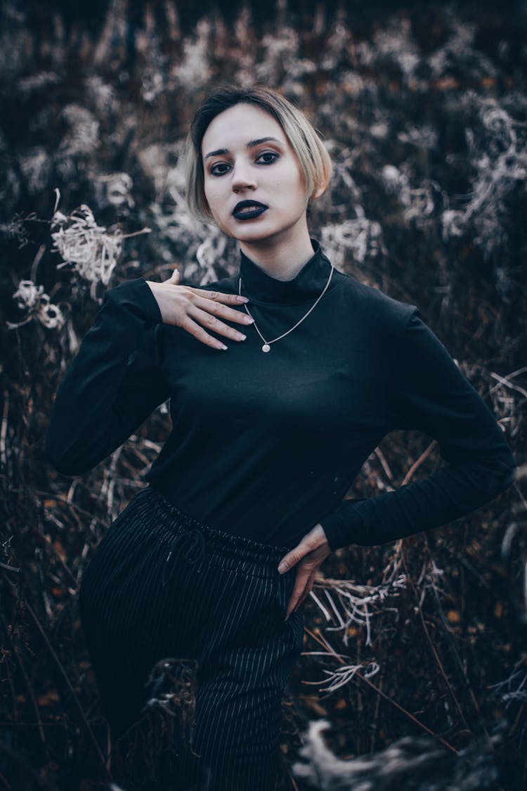 A Woman In Black Long Sleeve Shirt Wearing A Black Lipstick