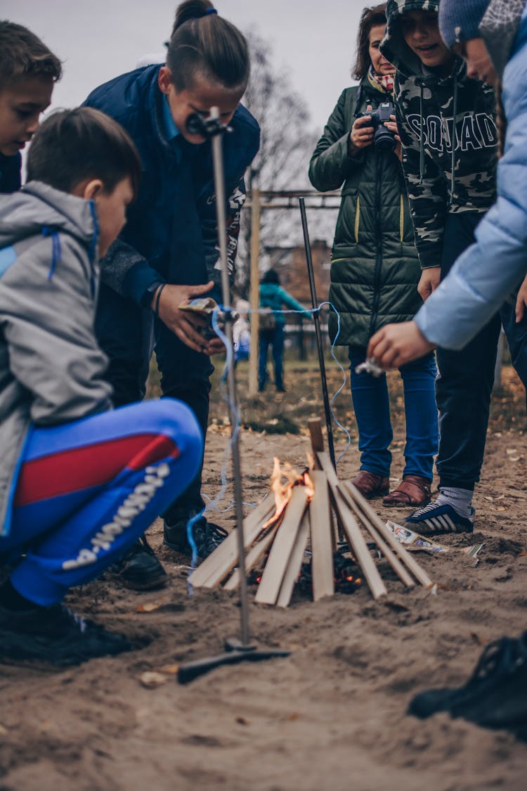 Teacher And Group Of Students Having Bonfire