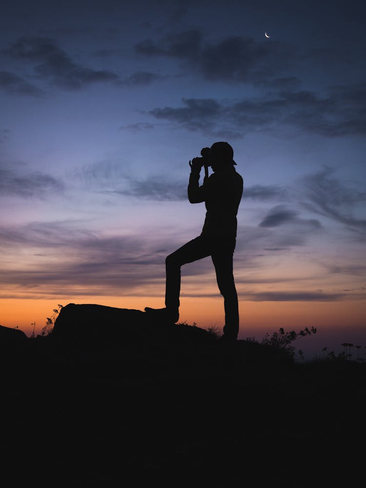 Silhouette Of A Man Looking Through Binoculars 