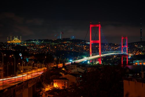 Free Captivating nighttime shot of Bosphorus Bridge with city lights illuminating Istanbul's skyline. Stock Photo