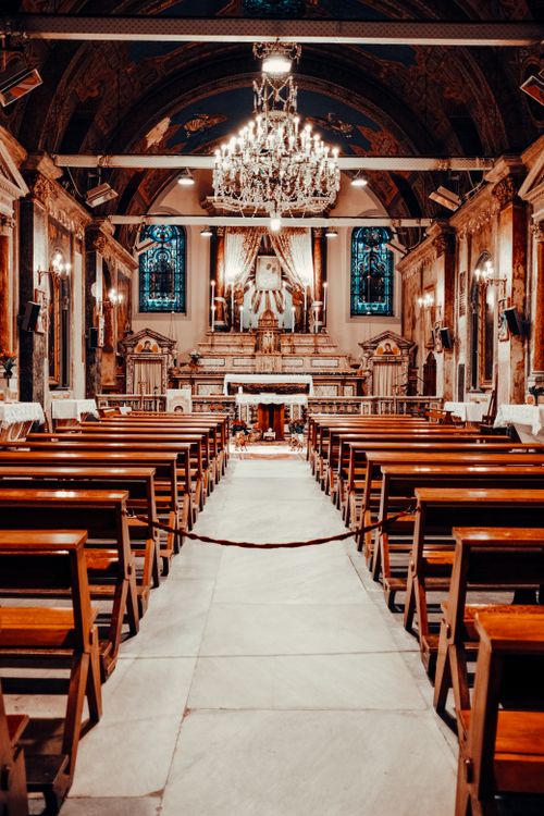 Free A beautiful wooden pews and altar in an ornate Catholic church. Stock Photo