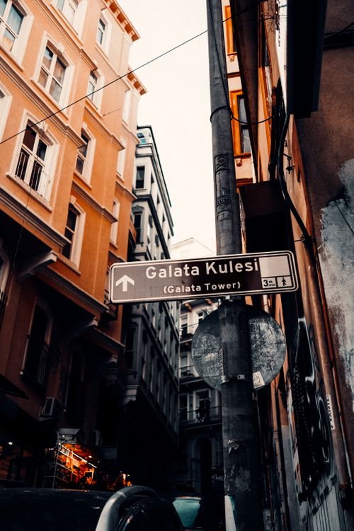 Free Direction sign to Galata Tower against charming historic Istanbul architecture, vibrant city vibe. Stock Photo