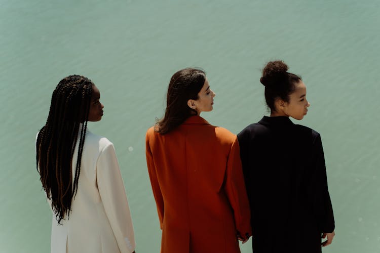 Women In Blazers Standing Beside Body Of Water