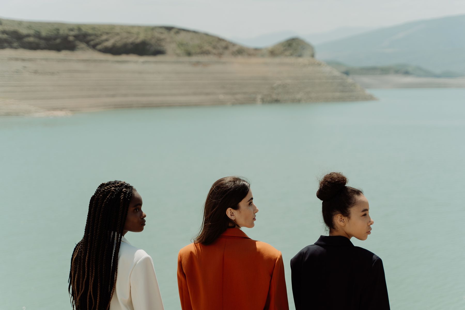 Three businesswomen overlooking a calm landscape