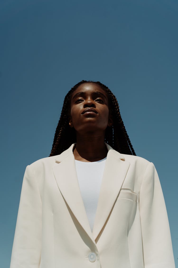 A Woman In White Blazer And Inner Top In Low Angle Shot
