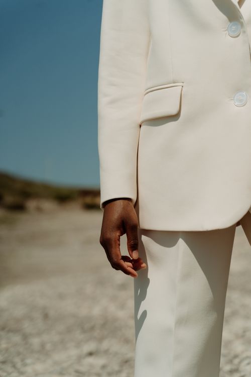 Free A stylish white suit showcased in a natural outdoor environment, focusing on elegant design. Stock Photo