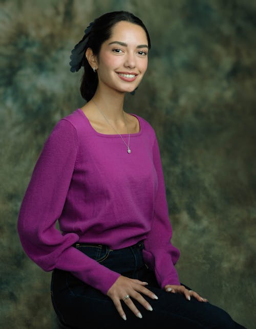 A Woman in Purple Long Sleeves Smiling