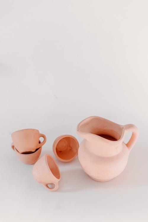 Clay Cups and Pot on White Background