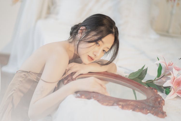 Woman Posing With Mirror And Flowers