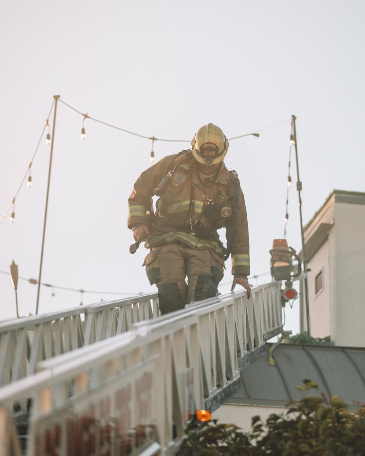 Firefighter Climbing Down The Ladder