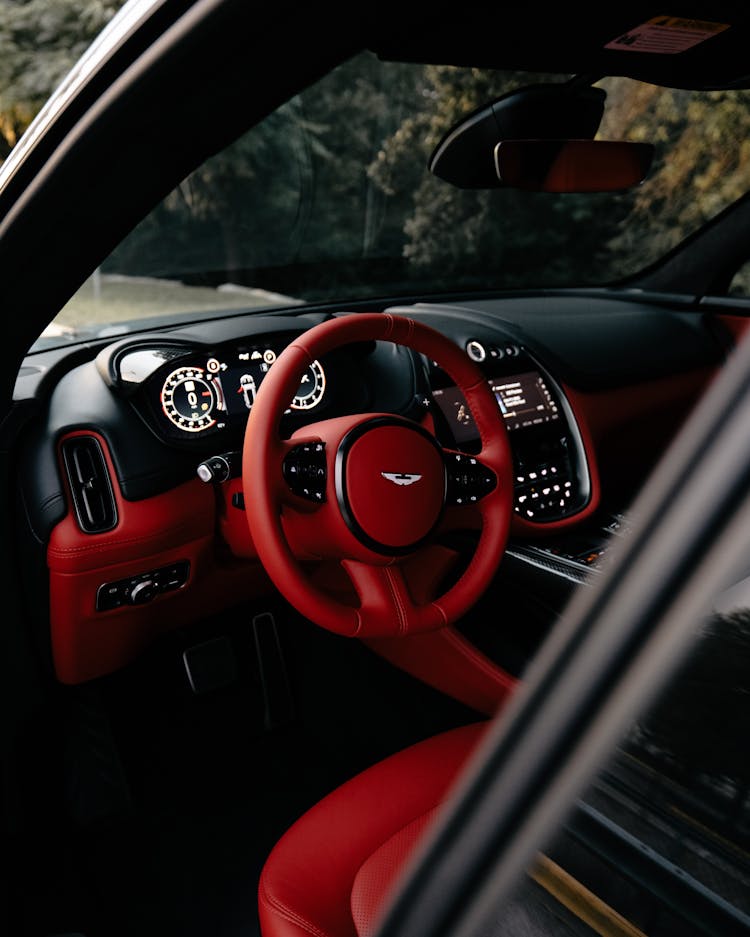 A Red And Black Car Interior Of An Aston Martin Car