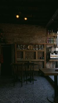 A warm and inviting cafe interior with brick walls and wooden furniture, perfect for relaxation.