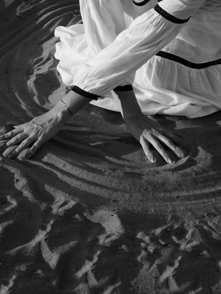 Woman Drawing On Sand 