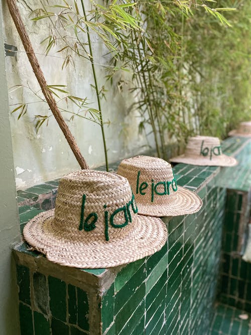 Straw Hats on a Brick Wall