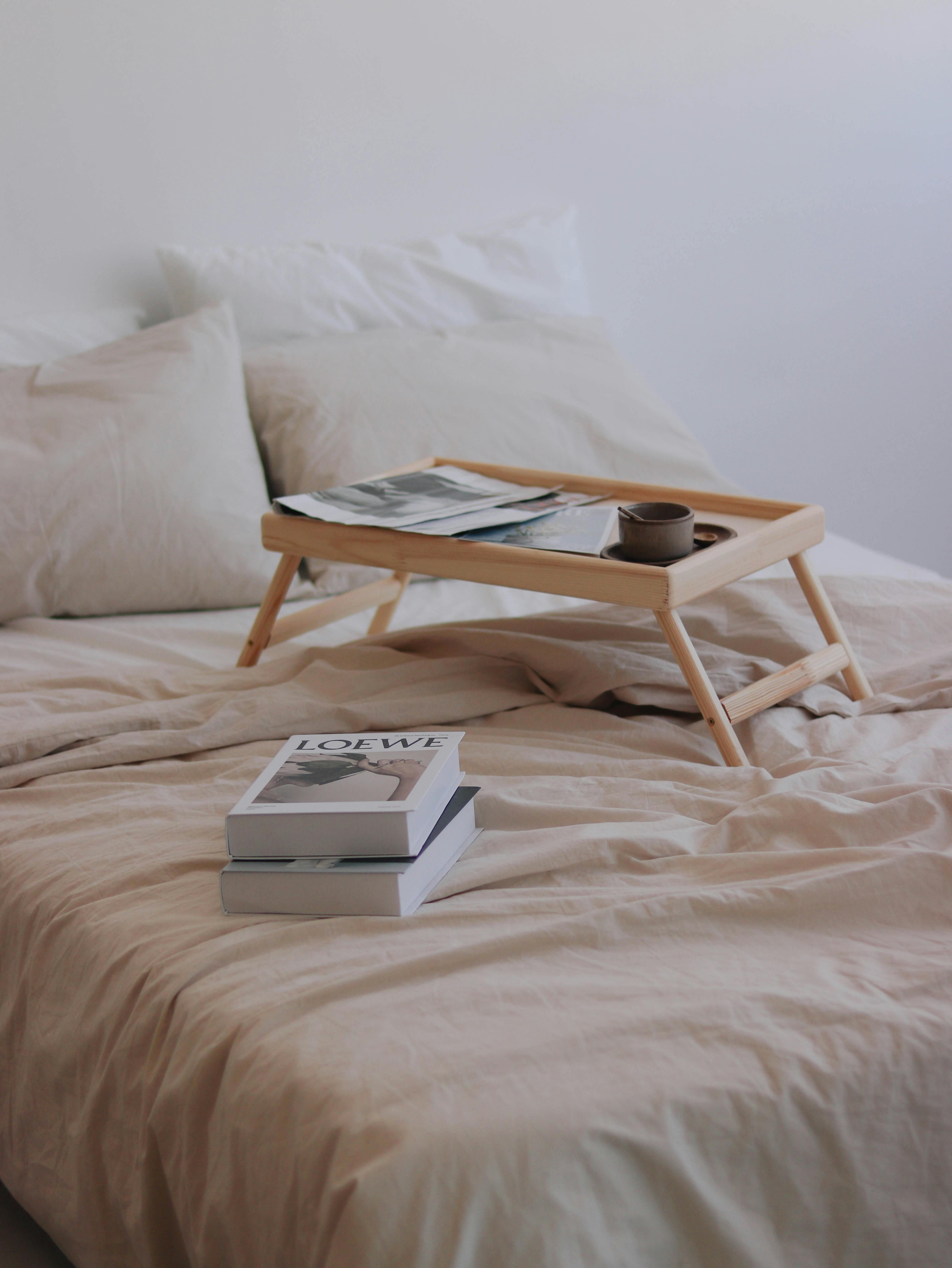 books and bed table laying on double bed