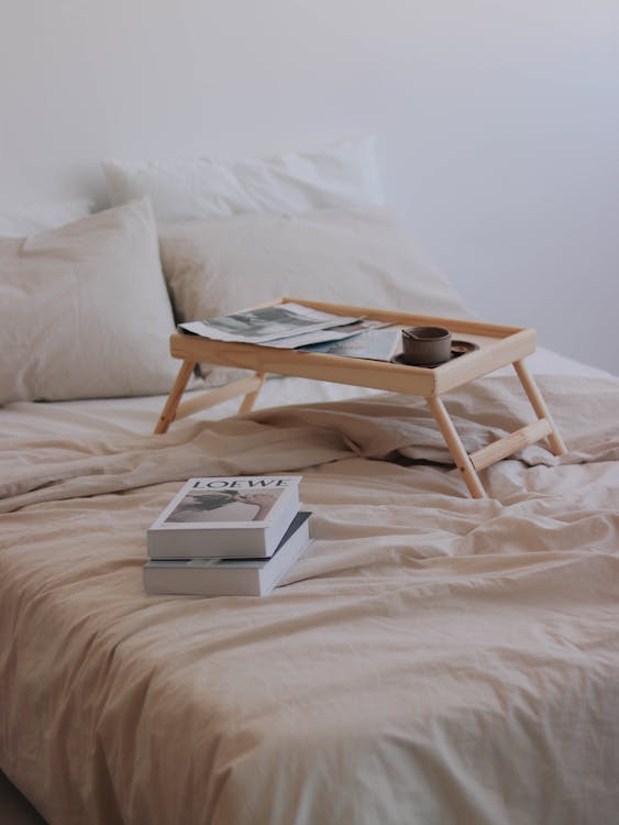 Free Books and bed table laying on double bed Stock Photo