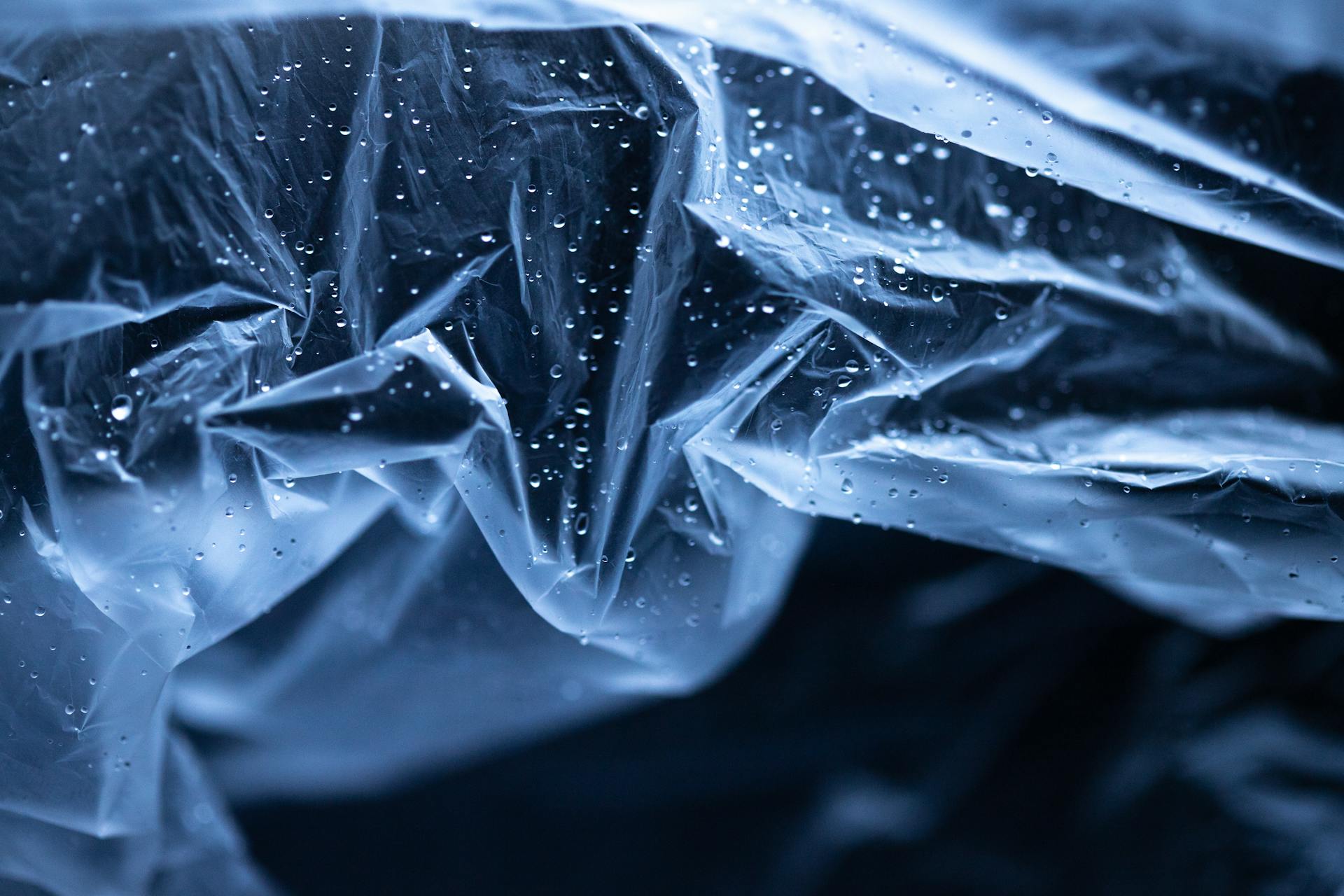 A Clear Creased Plastic with Water Droplets