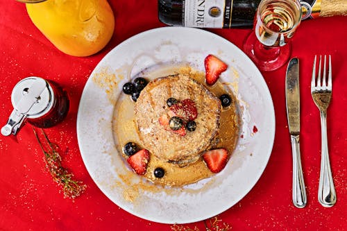 Free Pancakes on Plate on Table in Restaurant Stock Photo