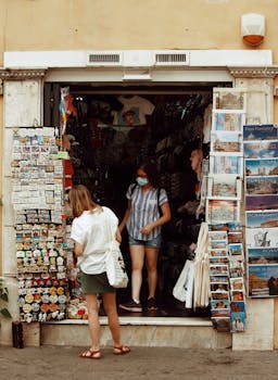 Tourists examine souvenirs at a busy Rome shop, showcasing Italian culture and travel memories.