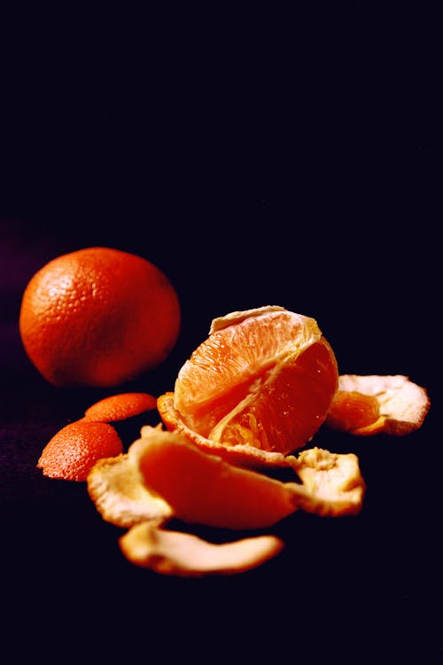 Free Peeled Orange Fruit on Black Surface Stock Photo