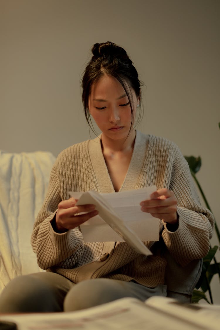 Woman Sitting And Reading Letter