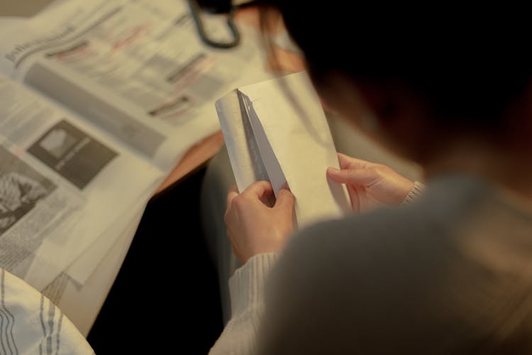 Rear View On Woman Opening Letter