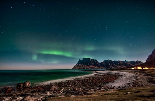 Stunning aurora borealis over the coastline of Lofoten Islands, Norway.
