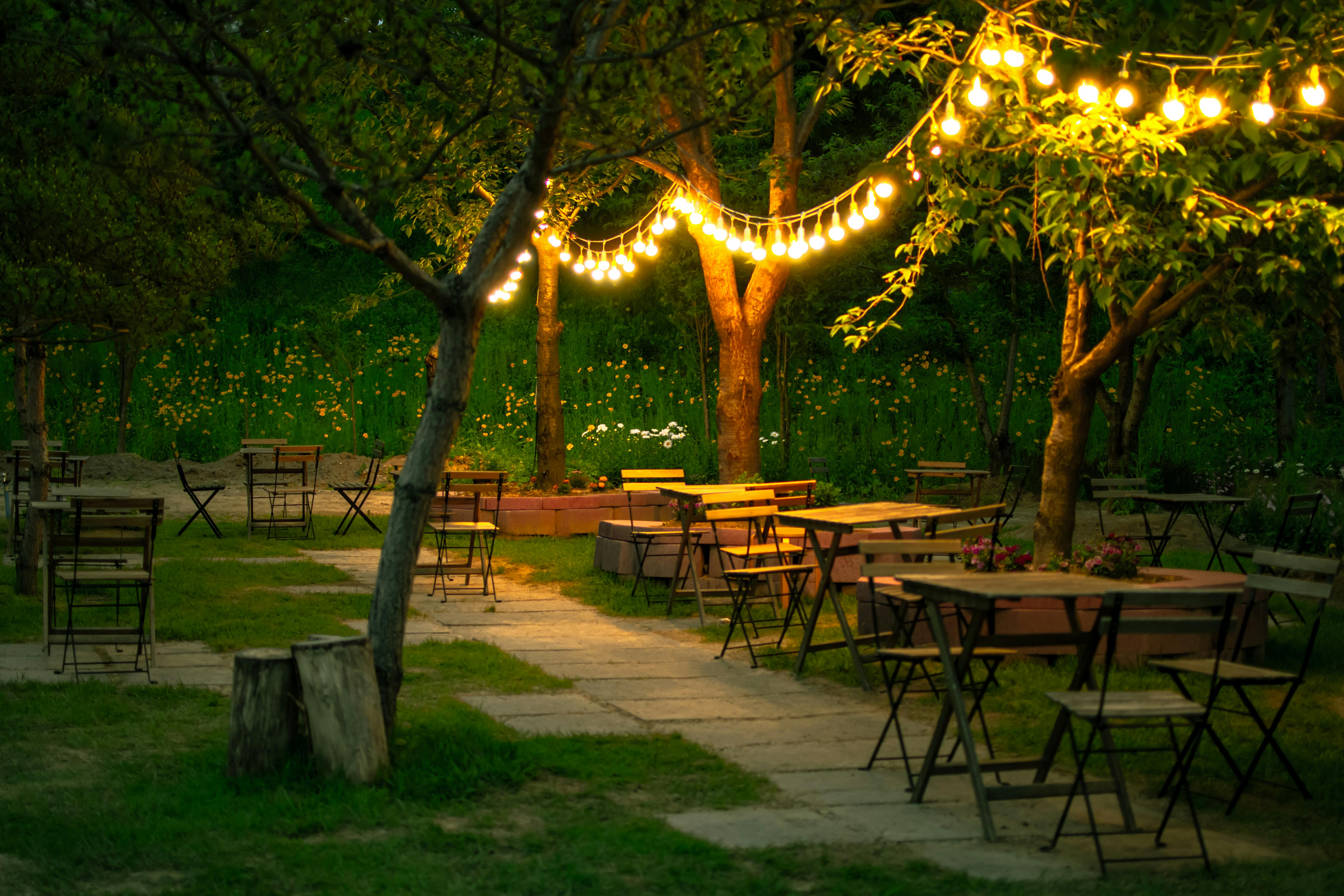Free A Restaurant in Garden Illuminated with String Lights Stock Photo