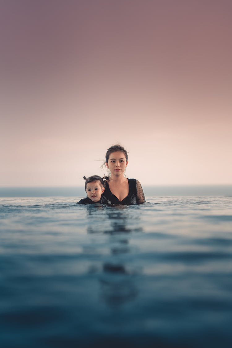 Photo Of Woman And A Girl Swimming