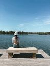 Woman in Brown Shirt Sitting on Brown Wooden Dock