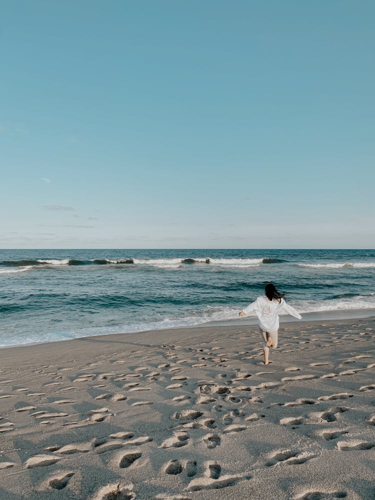 Woman Running On Beach