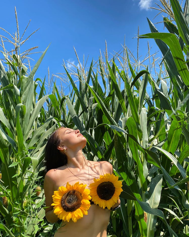 Woman Covering Her Chest With Yellow Flowers