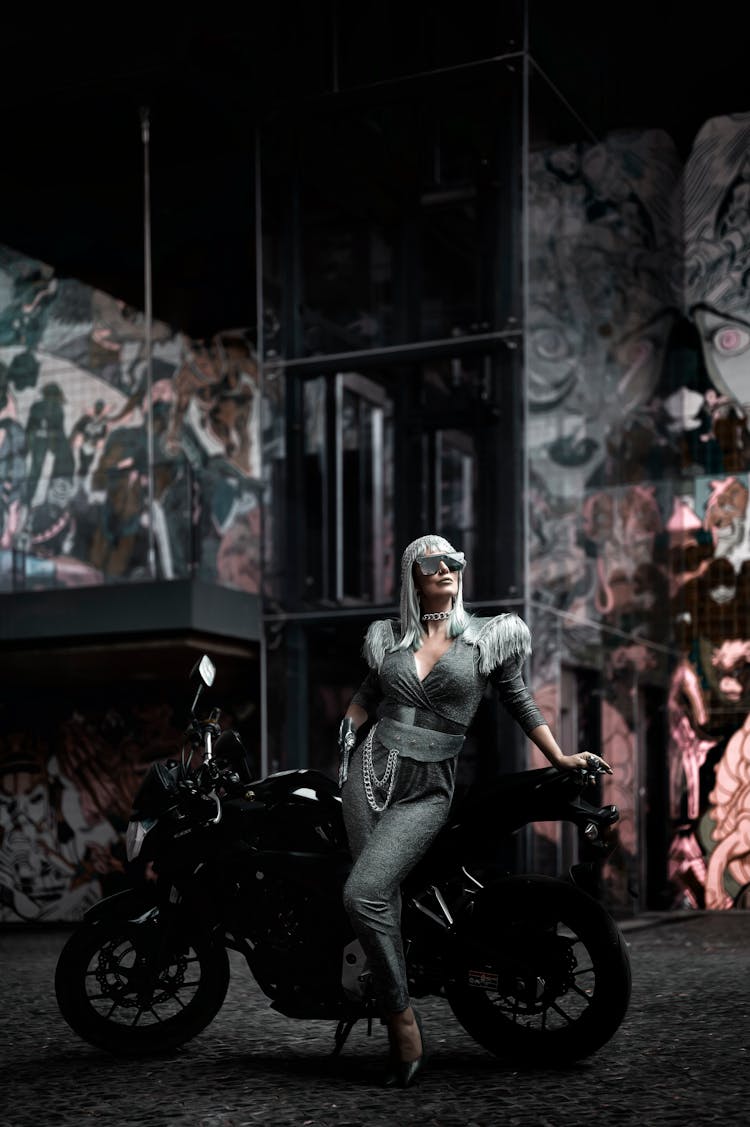 Portrait Of White Hair Woman Standing By Black Bike