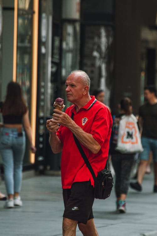 Man in Red Polo Shirt Holding an Ice Cream