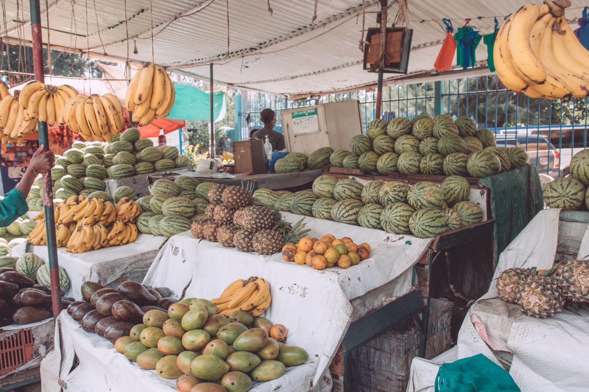 Stacked sisal kiondo baskets and beadwork on a Nairobi market stall