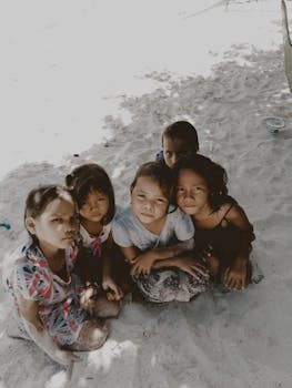 Five Toddlers Sitting on Sand