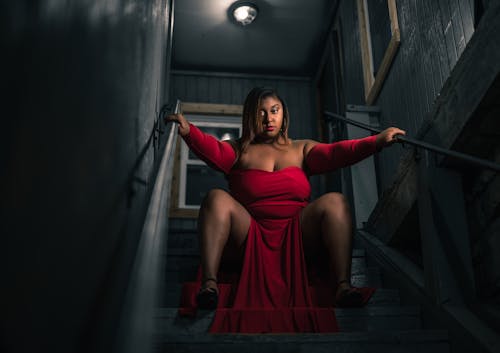Woman in Red Dress Sitting on Stairs