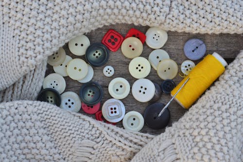 Assorted Buttons on the Wooden Surface