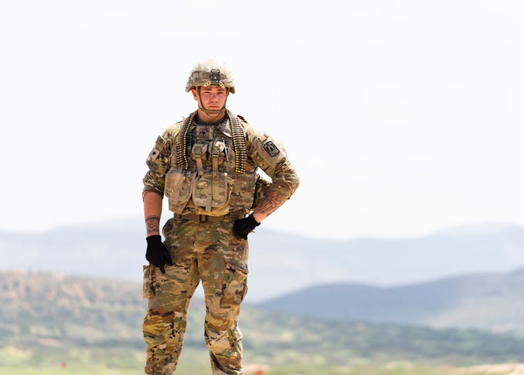 Unarmed US Soldier In Field Camo Uniform With Mountains In Background