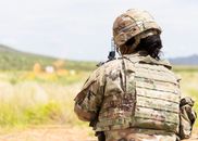 Man in Green and Brown Camouflage Uniform Wearing Black Helmet