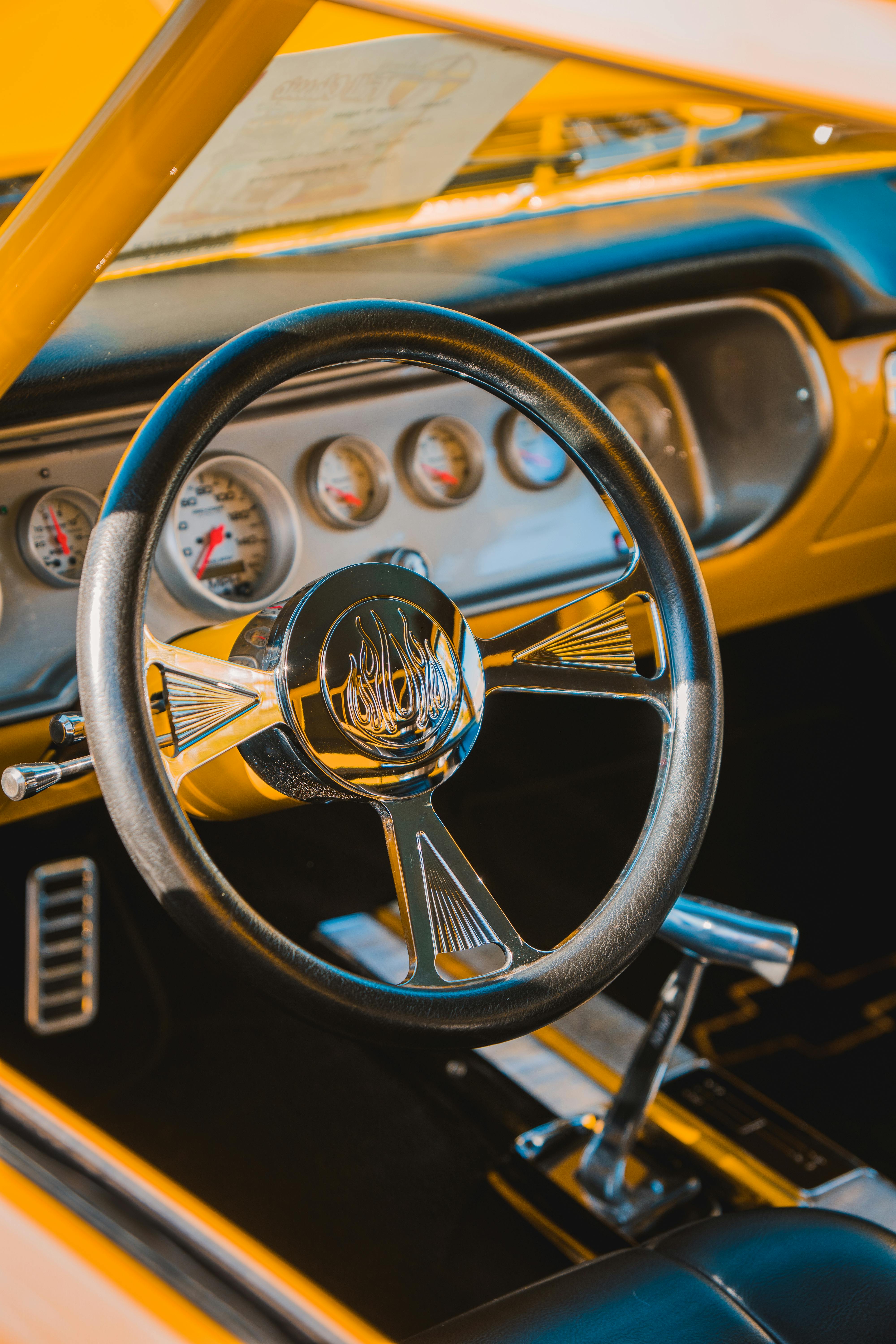 interior of yellow classic car with steering wheel and gear stick