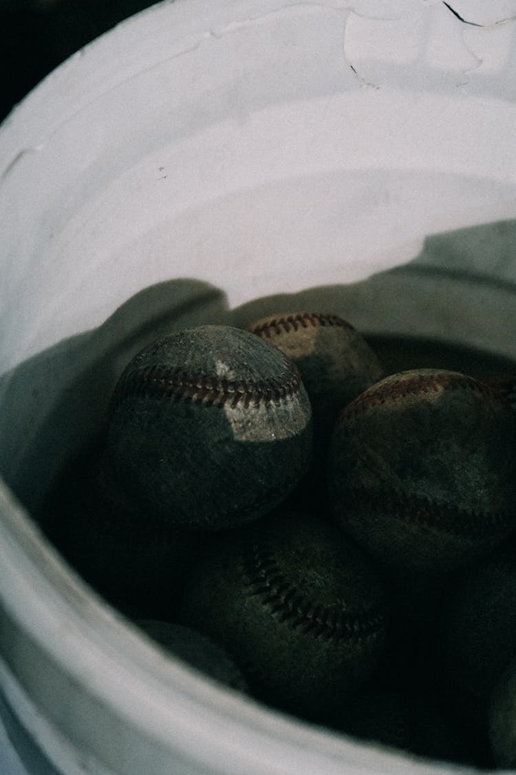 Dirty Baseballs In A White Bucket