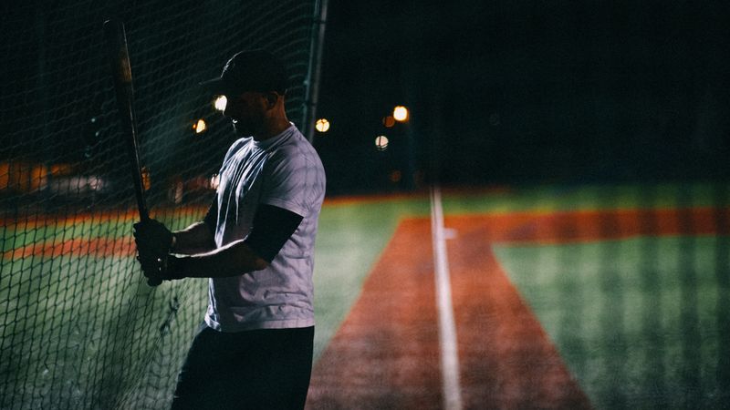 Batter at the plate under floodlights at night — photo by Mathias Reding on Pexels